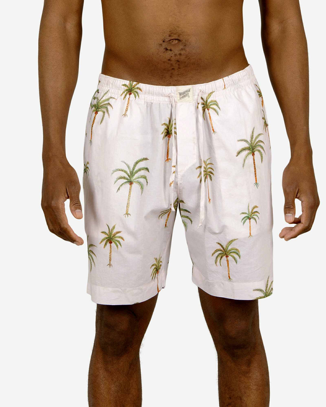 Mens lounge shorts with a palm tree pattern on a creme background