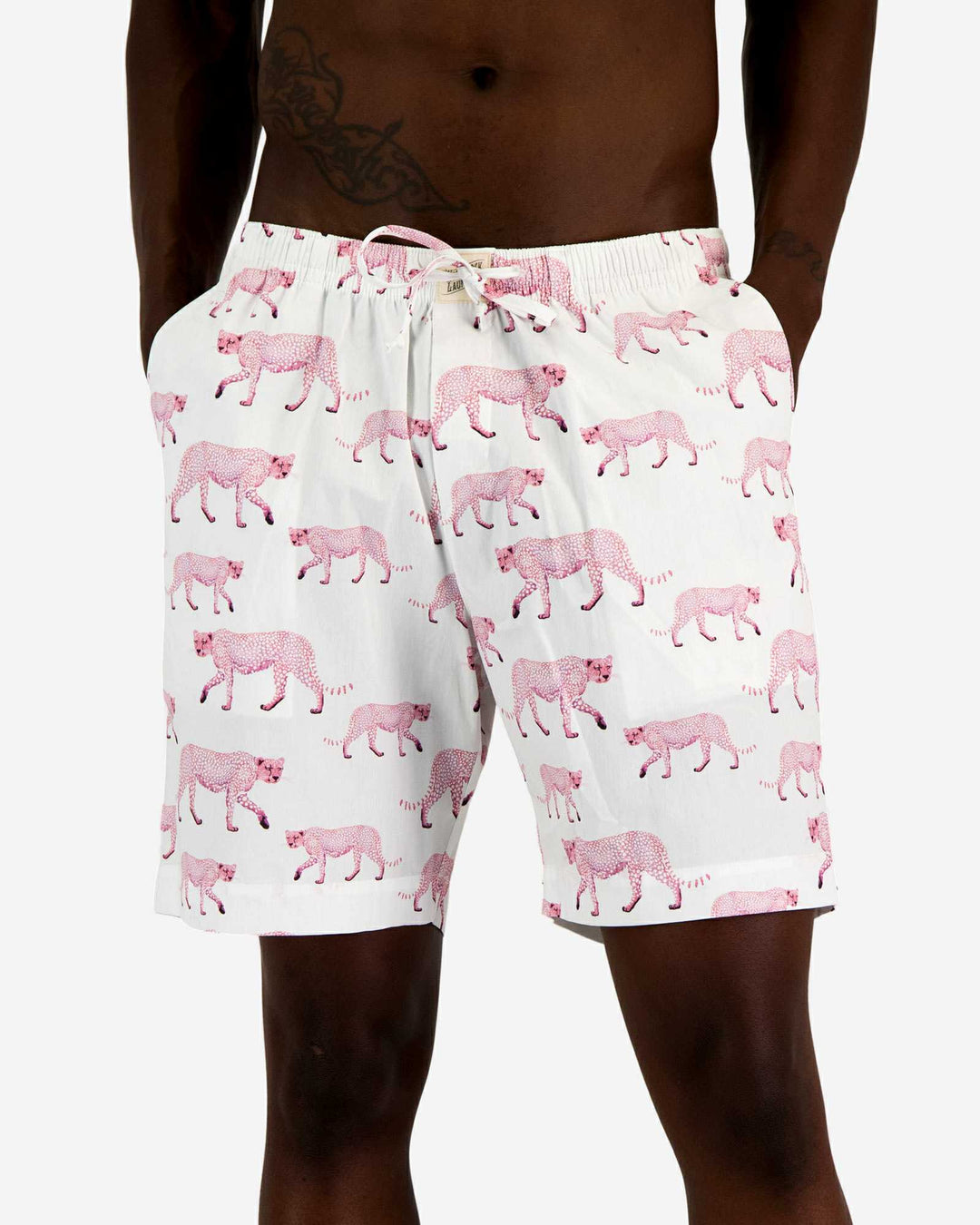 Mens lounge shorts with a pattern of pink cheetahs on a white background