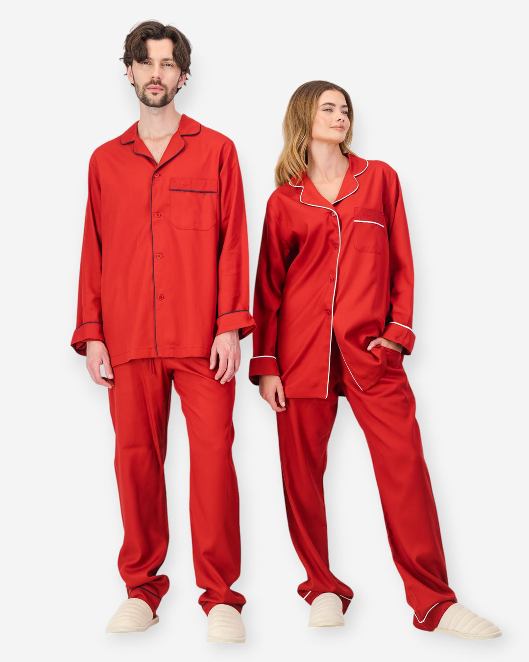 Two people wearing red tencel pyjama sets on a white background