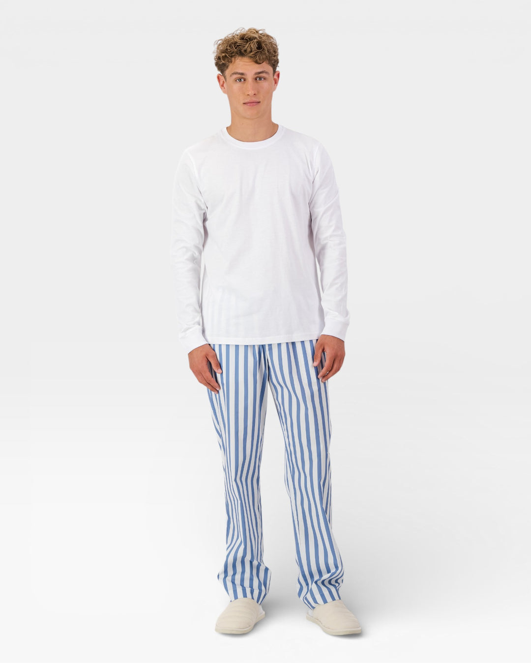 Mens blue and white striped trousers with white long-sleeved t-shirt.