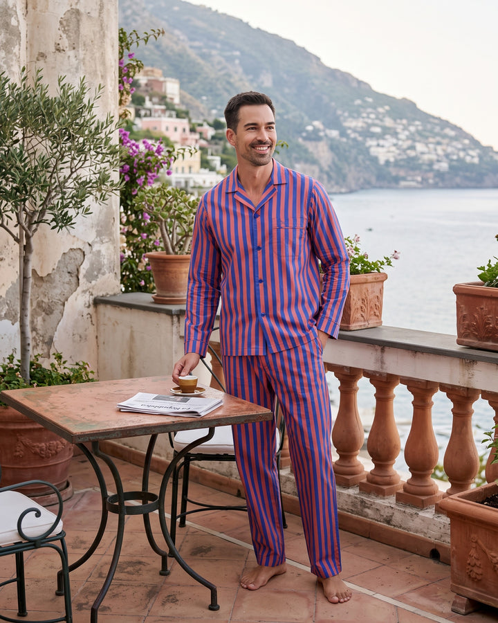 Man wearing blue and red striped pyjamas on a terrace in Positano, Italy