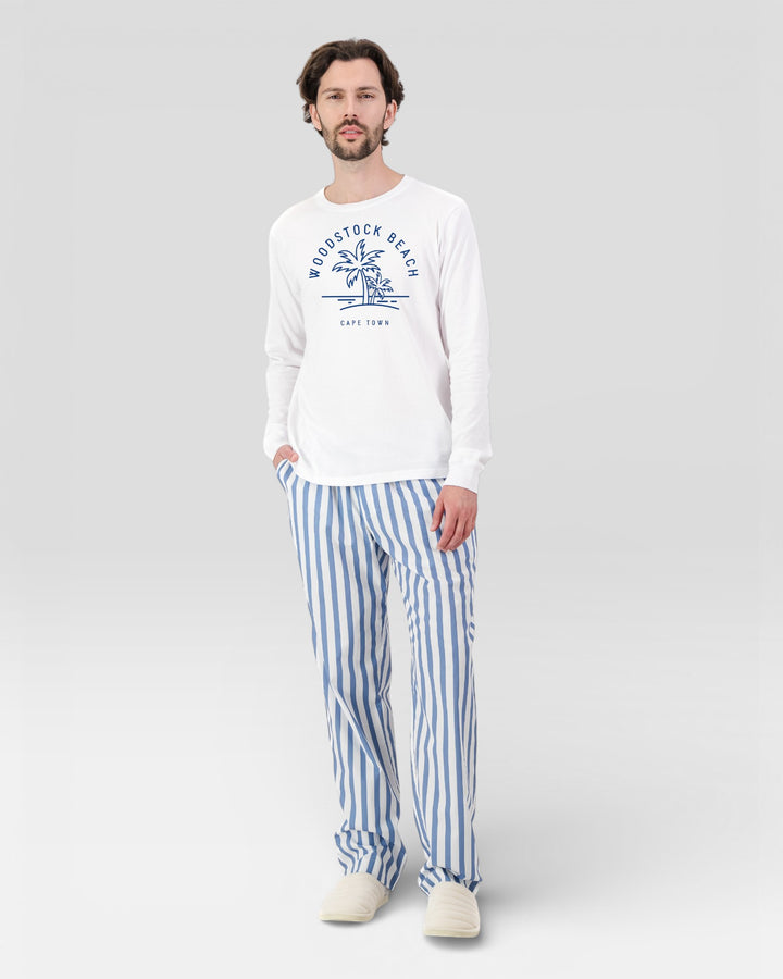Mens blue and white striped pants with white long-sleeved t-shirt with print.