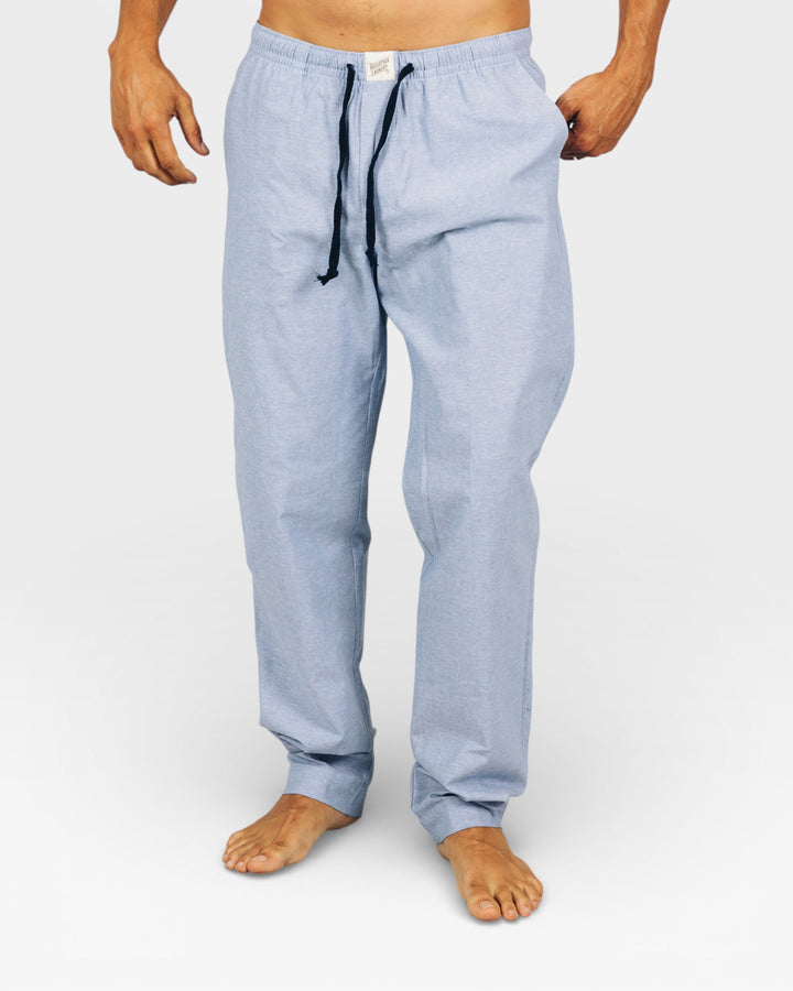 Mens light blue lounge pants in denim with a drawstring on a white background