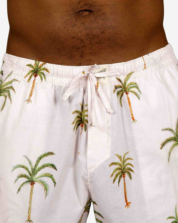 Mens lounge shorts with a palm tree pattern on a creme background