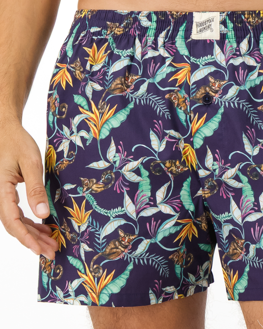 Close-up of mens boxer shorts with bush babies, tropical foliage and vibrant blooms