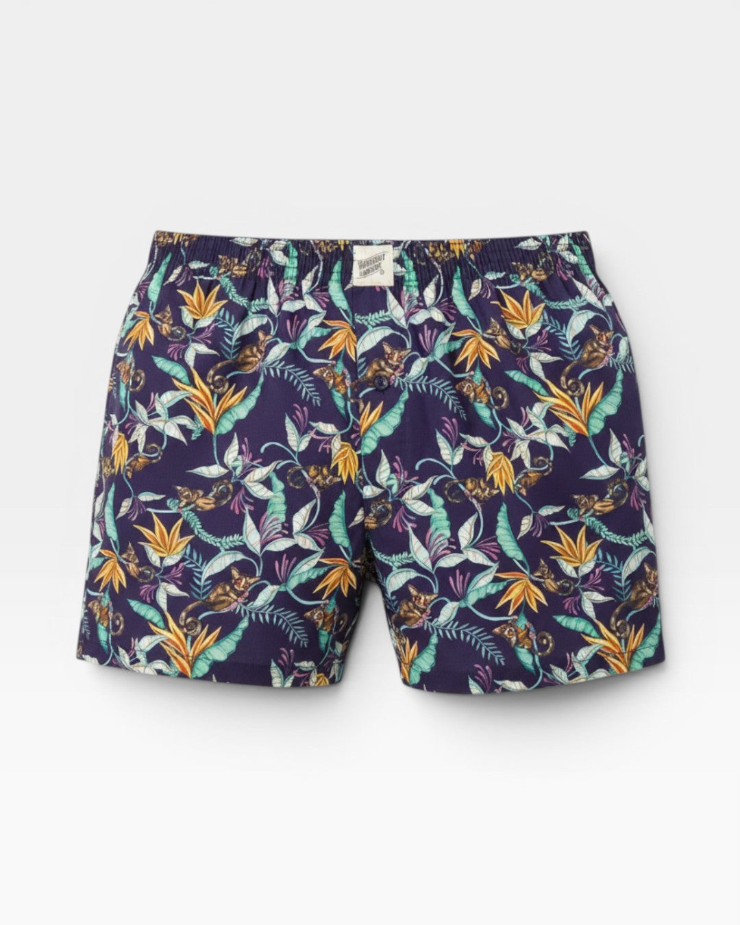 Mens boxer shorts with bush babies, tropical foliage and vibrant blooms on a navy background