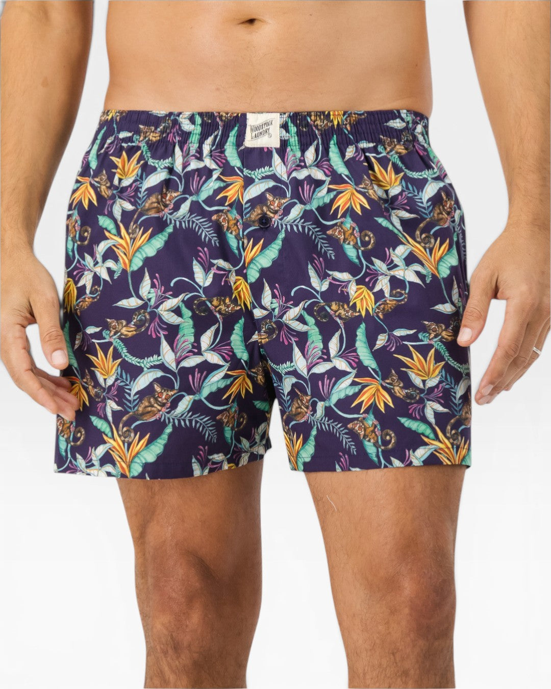 Front view of mens boxer shorts with bush babies, tropical foliage and vibrant blooms
