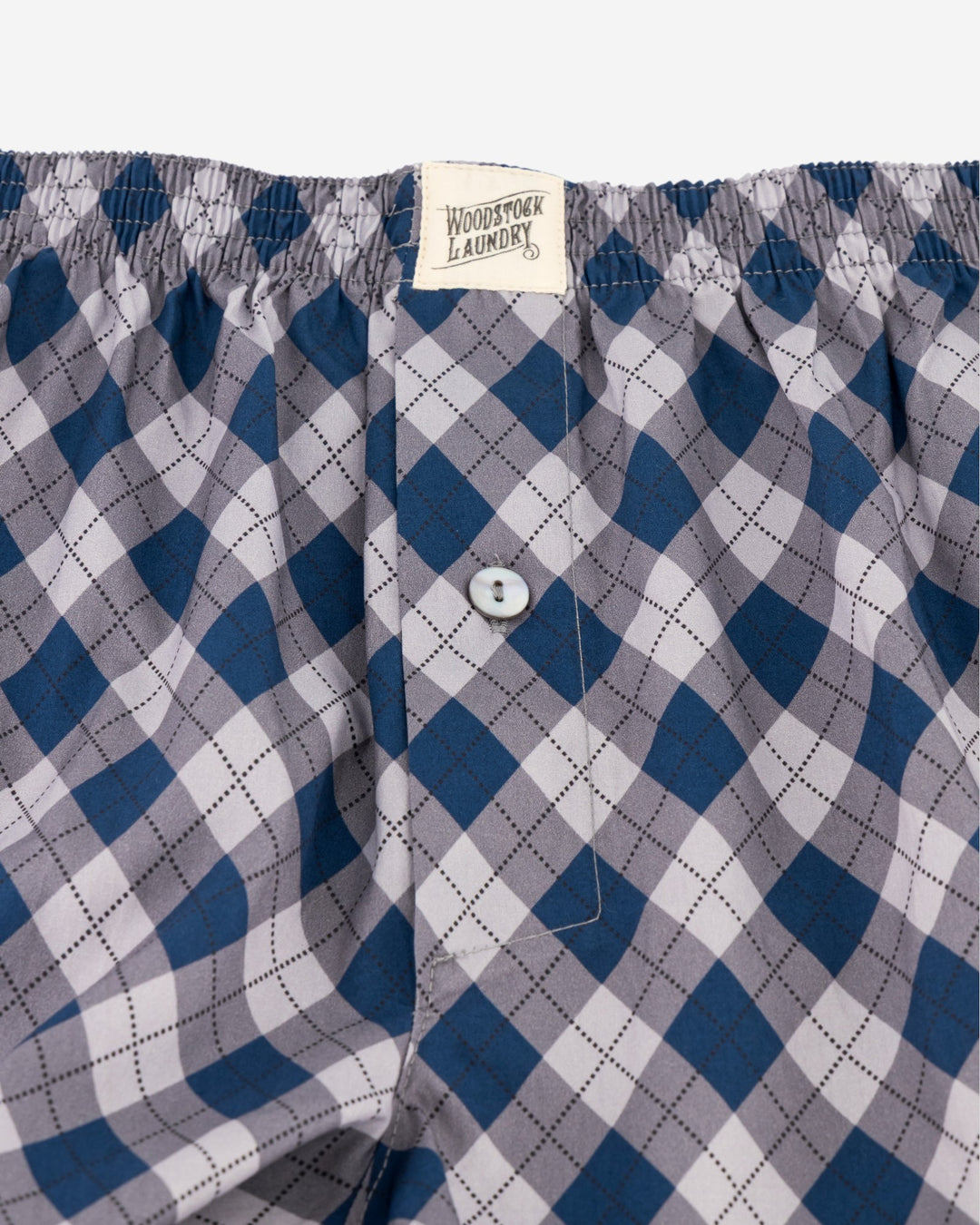Blue and gray checkered boxers with a button and Woodstock Laundry label.