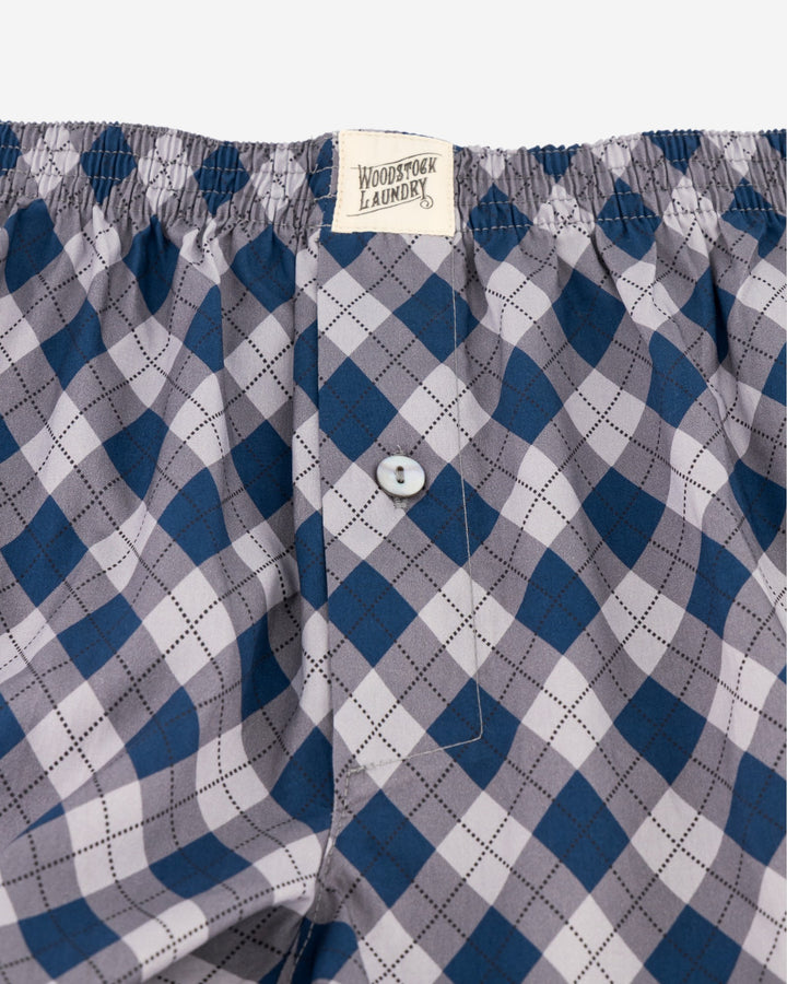 Blue and gray checkered boxers with a button and Woodstock Laundry label.