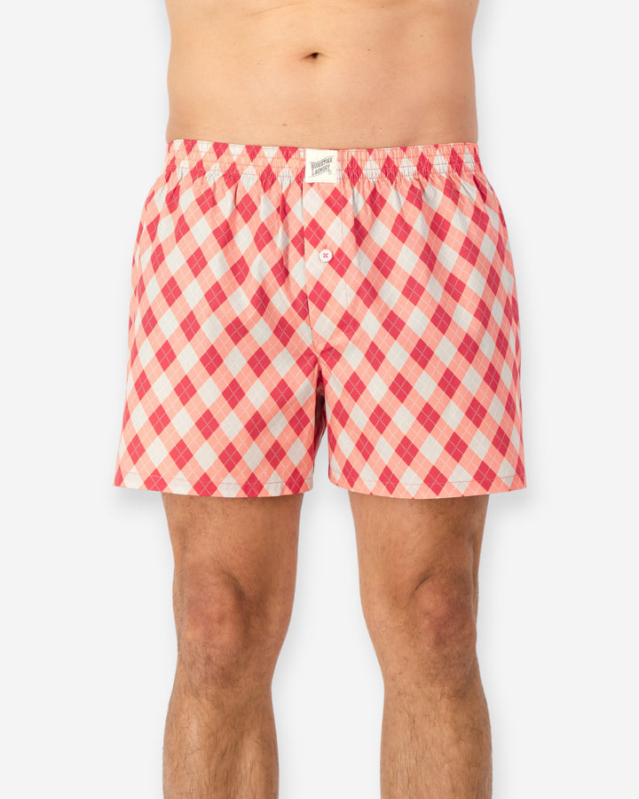 Red and white checkered boxer shorts on a white background